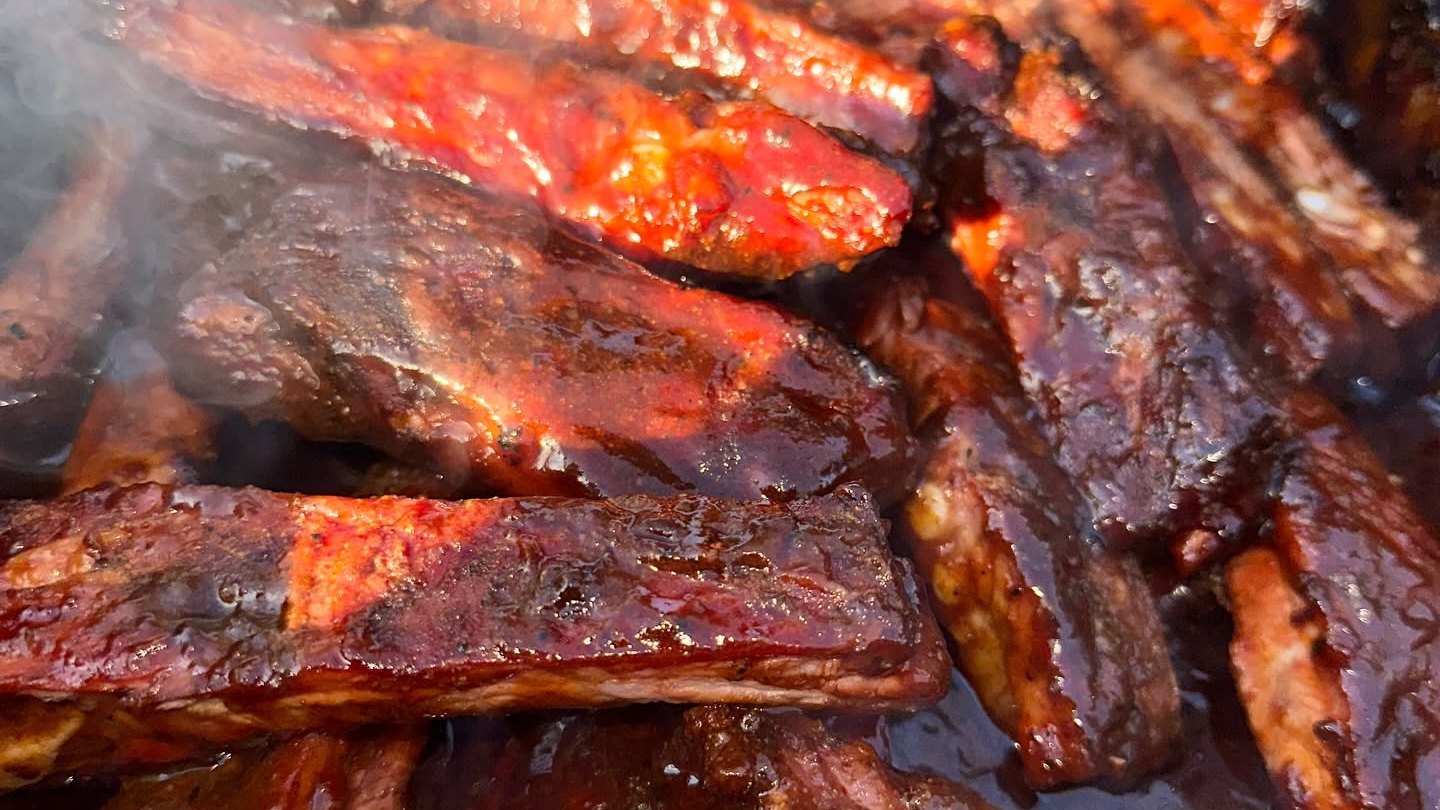 Sauced ribs steaming on a tray